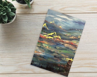 May include: Abstract landscape painting with a blue, green, and yellow color scheme. The painting depicts a mountain range with a cloudy sky in the background.
