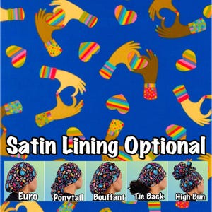 May include: A blue fabric with a pattern of rainbow hearts and hands making a heart shape. The text "Satin Lining Optional" is printed below the fabric. Five different styles of surgical caps are shown below the text: Euro, Ponytail, Bouffant, Tie Back, and High Bun.