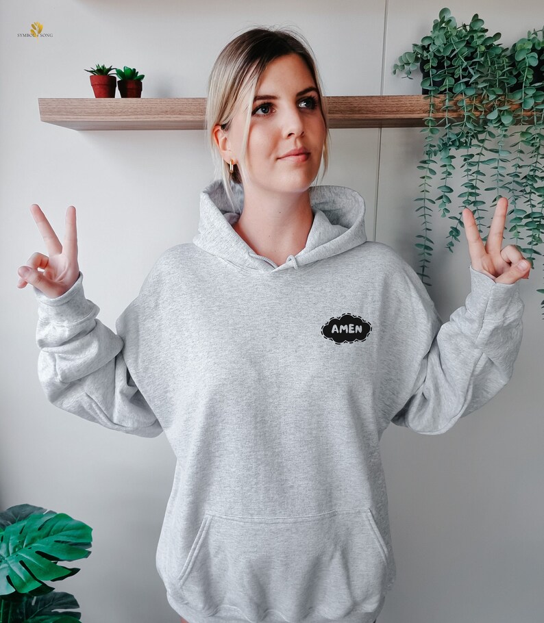 May include: A gray hooded sweatshirt with a black cloud-shaped patch that says "AMEN" in white lettering.