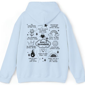 May include: Light blue hoodie with a black print of daily reminders with bible verses and illustrations. The print includes phrases like "be courageous", "walk in love", and "choose joy".