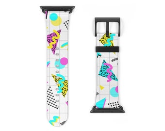 May include: A white Apple Watch band with a geometric pattern in bright colors, including pink, blue, yellow, and black. The band is made of silicone and has a black buckle.