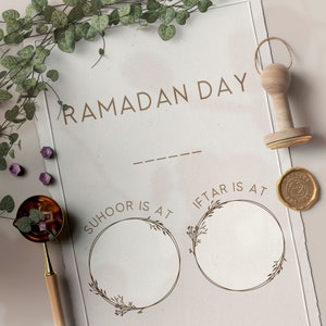 May include: A printable Ramadan Day planner with two blank circles for writing in the times for Suhoor and Iftar. The planner has a brown background with a decorative border.