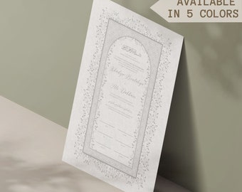 May include: A white wedding invitation with a decorative border of leaves and an ornate archway. The invitation includes the names "Widadya Pradalya" and "Ali Dahham" and Arabic text.