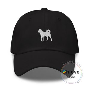 May include: Black baseball cap with a white embroidered Shiba Inu dog design. The cap has a curved brim and an adjustable strap. The text "Dhlove Style" is printed on the side.