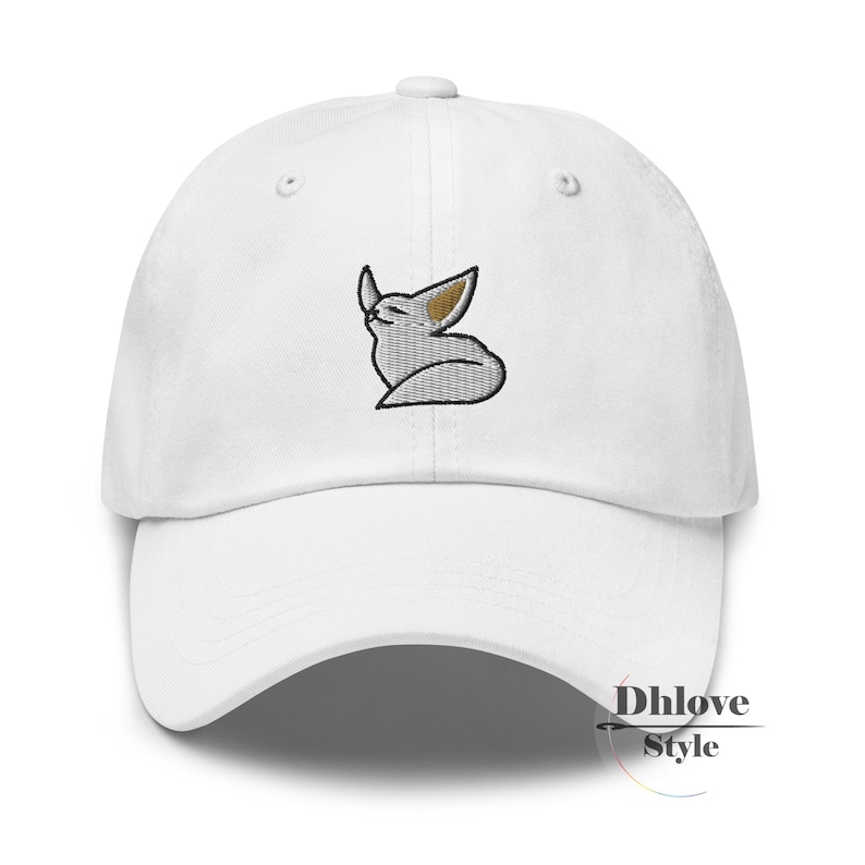 May include: White baseball cap with a curved peak. The cap has an embroidered design of a stylized fox with a black outline, grey body, and tan ears. The text "Dhlove Style" is printed on the side.