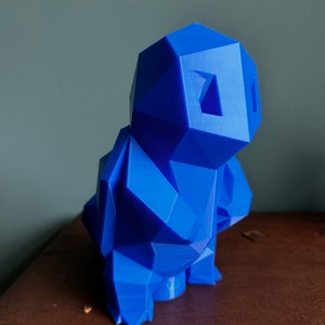 May include: A blue 3D printed geometric sculpture of a stylized animal. The sculpture has a blocky, angular design and is made of a smooth, solid material.
