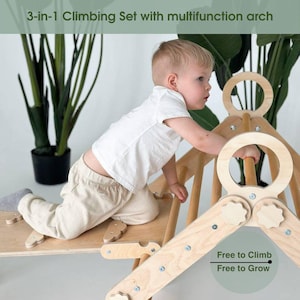May include: A wooden 3-in-1 climbing set with a multifunction arch. The set includes a climbing arch, a ramp, and a wooden board. The text "Free to Climb, Free to Grow" is visible. A young child is climbing on the set.