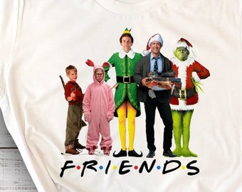 May include: White t-shirt with a graphic print of characters from the movies "Elf" and "How the Grinch Stole Christmas". The characters are standing in a line and the text "FRIENDS" is printed below them.