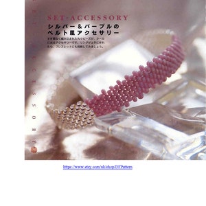 May include: A close-up of a silver and purple beaded bracelet. The bracelet is made with small, round beads that are tightly woven together. The beads are arranged in a pattern that creates a subtle, yet elegant design. The bracelet is a beautiful example of fine craftsmanship.