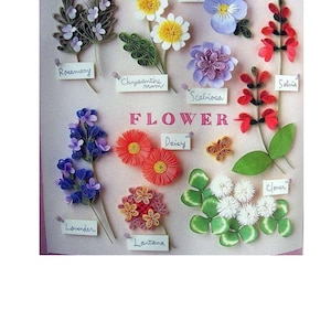 May include: A collection of paper flowers, each with a different name tag. The flowers are made of curled paper and are arranged in a grid pattern. The flowers include rosemary, chrysanthemum, pansy, salvia, scaliosa, daisy, lantana, lavender, and clover.