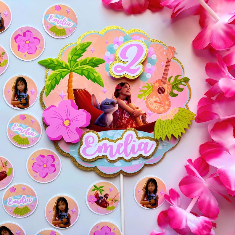 Op de afbeelding: Een kleurrijke taarttopper met een tropisch thema. De topper toont een meisje met Stitch, een palmboom, een ukelele en het nummer 2. Extra ronde stickers met de naam "Emelia" en een meisje met Stitch zijn ook inbegrepen.