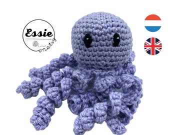 May include: A crocheted purple octopus with black eyes. The octopus has eight tentacles.