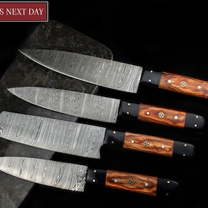 May include: Set of four kitchen knives with Damascus steel blades and wooden handles with brass accents. The knives are arranged on a dark gray surface.