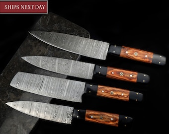 May include: Set of four kitchen knives with Damascus steel blades and wooden handles with brass accents. The knives are arranged on a dark gray surface.