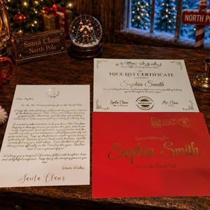 May include: A white letter addressed to Sophia Smith from Santa Claus, a Nice List certificate for Sophia Smith, and a red envelope with gold lettering. The letter contains text from the North Pole, and the certificate features official seals.