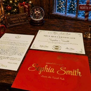 May include: A red envelope with gold text reading Special delivery for Sophia Smith From the North Pole, a white Nice List Certificate for Sophia Smith with Santa and Mrs. Claus signatures, and a white letter from Santa Claus with gold text.