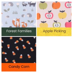 May include: Three fabric swatches: a light blue pattern with foxes, hedgehogs, and snails labeled Forest Families; a light pink pattern with colorful apples labeled Apple Picking; and a black pattern with candy corn labeled Candy Corn.