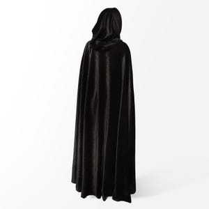 May include: A black hooded cape made of a soft, flowing fabric. The cape is long and reaches the floor.
