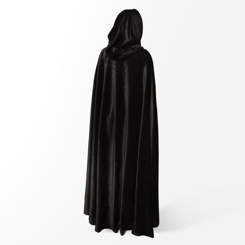 May include: A black hooded cape made of a soft, flowing fabric. The cape is long and reaches the floor.