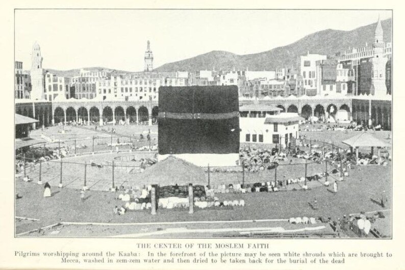 May include: A black and white photo of a large crowd of people gathered around a black cube-shaped building. The building is surrounded by a courtyard with a fence and a few trees. The photo is taken from a high angle, looking down on the crowd. The text "THE CENTER OF THE MOSLEM FAITH" is printed below the image.