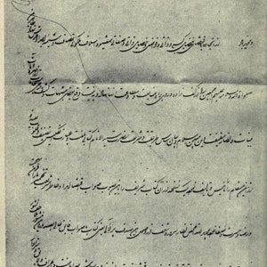 May include: A black and white image of a handwritten letter in Persian script. The letter is written on a piece of paper with a faded, aged appearance. The text includes the phrase "Nasir ud-din Shah."