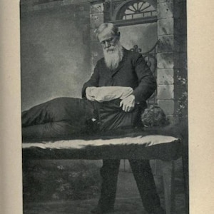 May include: A black and white photo of a man performing a back and shoulder treatment on a patient lying on a table. The photo is labeled "PLATE XXXI. - Back and Shoulder Treatment."