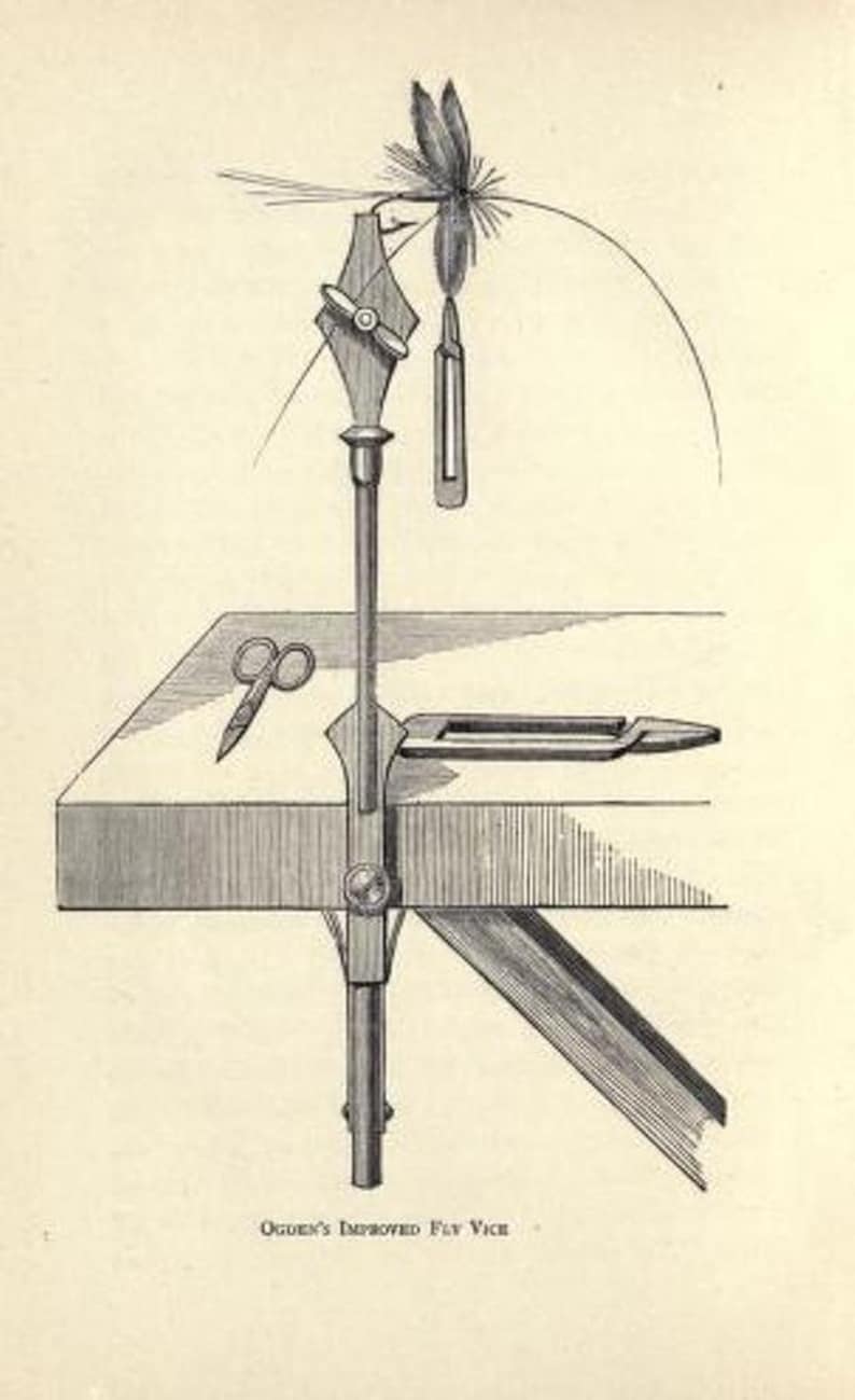 May include: A black and white illustration of a fly tying vise, a tool used to hold a hook while tying a fly. The vise is mounted on a wooden base and has a lever to tighten the hook. A fly is shown tied to the hook, and a pair of scissors are on the base.