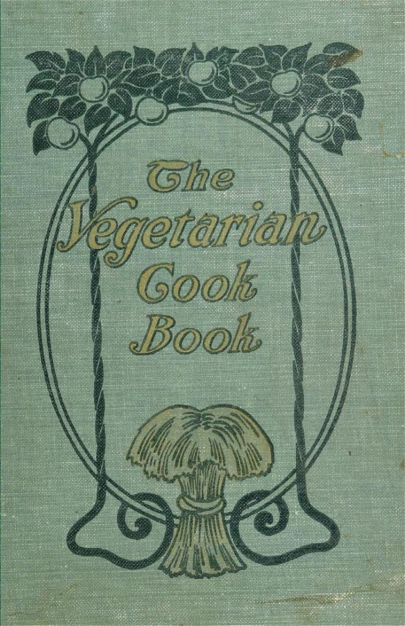 May include: The cover of a vintage cookbook titled "The Vegetarian Cook Book". The cover is a light green with a dark green border and a decorative design of two trees with apples and a sheaf of wheat.