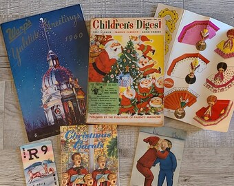 May include: A collection of vintage Christmas-themed magazines and paper crafts. The magazines include "Warpe Yuletide Greetings 1960", "Children's Digest", and "Christmas Carols". The paper crafts feature cut-out angels and a Christmas tree.