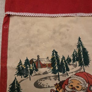 May include: A vintage Christmas stocking with a red felt top and a white lace trim. The stocking features a printed scene of Santa Claus in a snowy forest with a small house in the background.