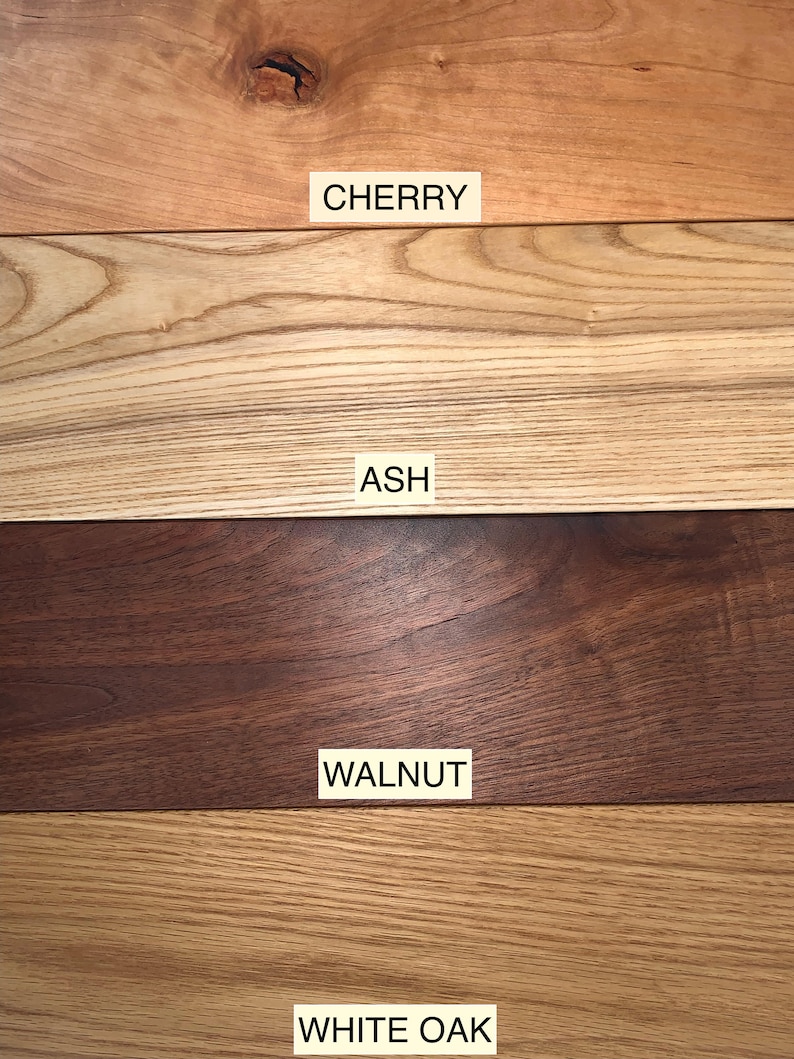 May include: Close-up of four different types of wood: cherry, ash, walnut, and white oak. Each wood sample is labeled with its name.