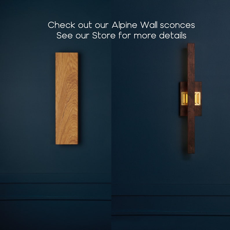 May include: Two wooden wall sconces, one with a natural wood finish and the other with a dark brown finish. Both sconces are rectangular in shape and feature a gold metal accent.
