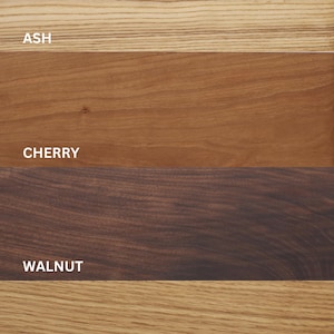 May include: Close-up of four different wood samples: ash, cherry, walnut, and white oak. Each sample is labelled with its wood type.