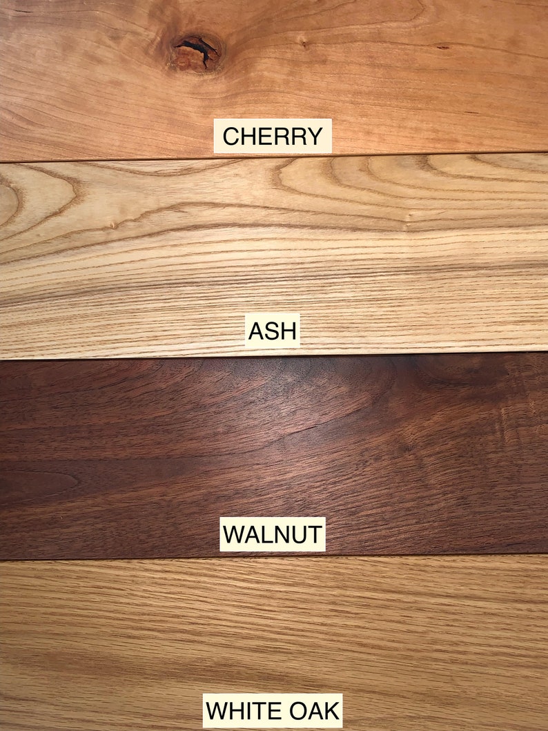 May include: Close-up of four different types of wood: cherry, ash, walnut, and white oak. Each wood sample is labeled with its name.