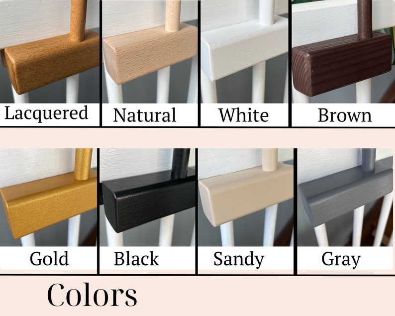 May include: A close-up of ten different color options for a wooden crib rail. The colors are lacquered, natural, white, brown, gold, black, sandy, gray, and two shades of gray.