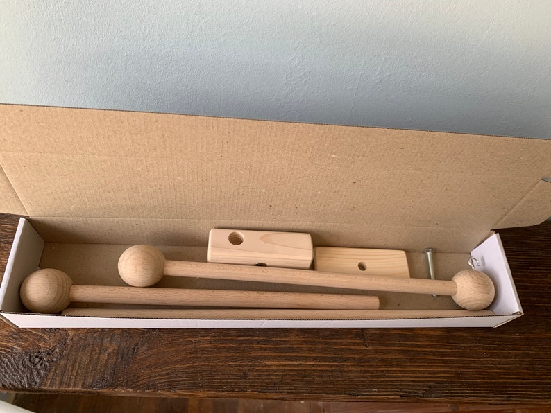 May include: A set of wooden curtain rods with round finials, packaged in a cardboard box. The rods are unfinished and ready to be painted or stained.