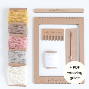 May include: A weaving kit with a wooden frame, comb, needle, and white thread. It includes spools of yarn in yellow, brown, pink, gray, and cream colors. The kit also includes a PDF weaving guide.