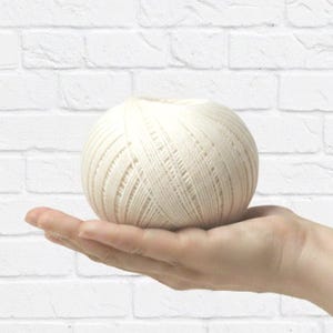 May include: A set of three ceramic mugs with a speckled, matte finish. The mugs are in shades of cream, light brown, and dark brown. Each mug has a simple, minimalist design, ideal for coffee or tea.