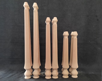 May include: Set of eight wooden table legs with fluted details. The legs are various sizes and are unfinished.