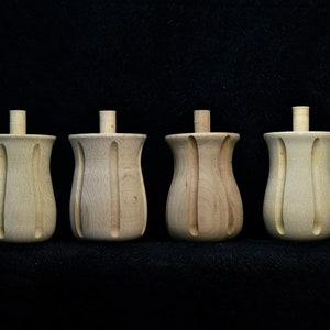 Op de afbeelding: Vier houten meubellepoten met een gedraaid, geribbeld ontwerp. De poten zijn onbewerkt en hebben een natuurlijke houtkleur.