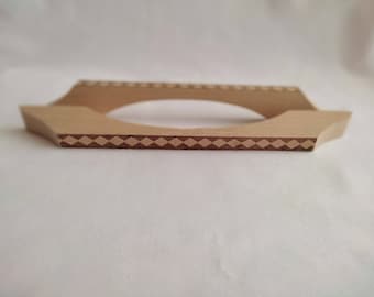 May include: A wooden stand with a diamond pattern inlay. The stand has a rounded opening in the center.