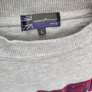 May include: Gray sweatshirt with a Kangol Sport logo and a size label that says "L" and "Men's".
