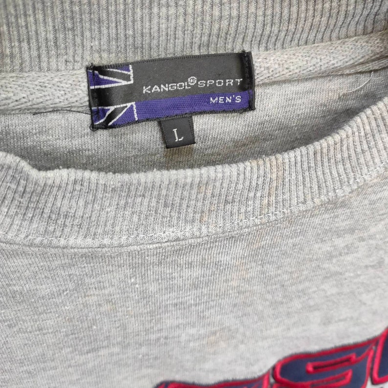May include: Gray sweatshirt with a Kangol Sport logo and a size label that says "L" and "Men's".