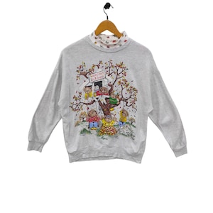 May include: Gray sweatshirt with a graphic of bears playing in a treehouse. The treehouse has a sign that reads "Bearly There Club House".