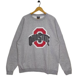 May include: Grey sweatshirt with a large red and black Ohio State logo. The logo features a large "O" with the words "Ohio State" around it.