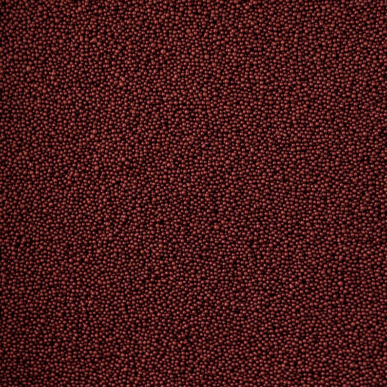 May include: A close-up image of a red, textured surface covered in small, round beads.