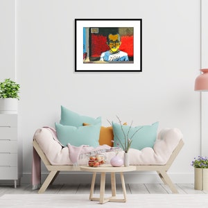 May include: A framed painting of a young person wearing glasses and a white shirt with a blue and yellow design. The background is a red and blue abstract design.