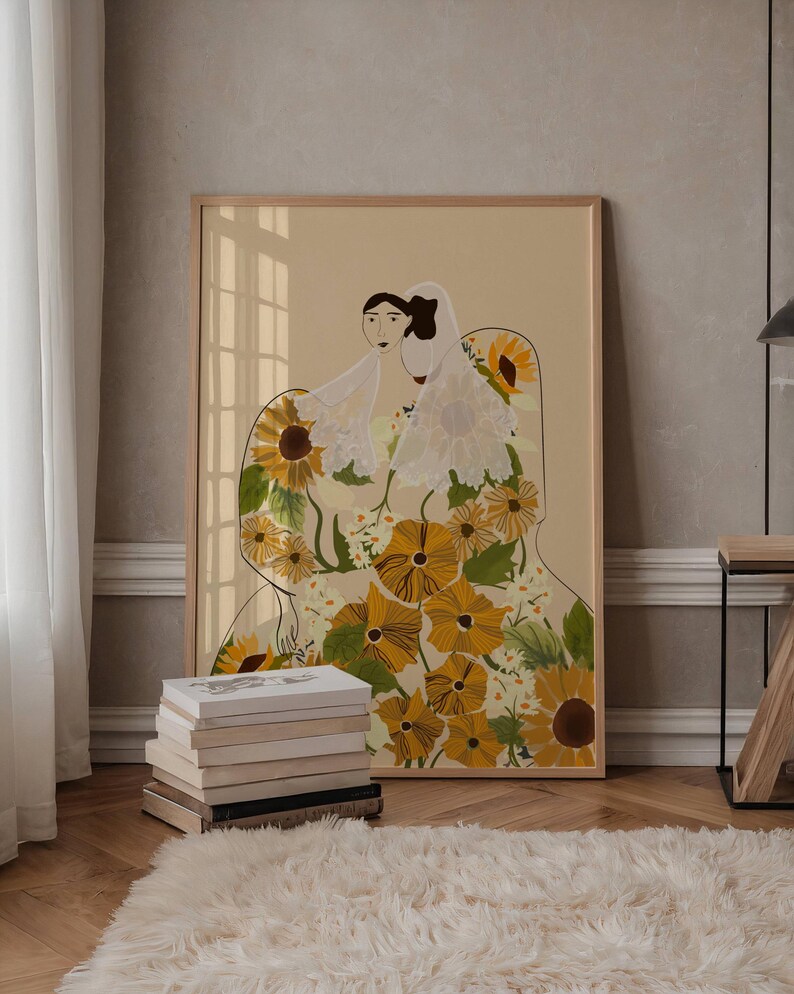 May include: A framed illustration of two women wearing veils and standing in a field of sunflowers. The women are facing each other and the sunflowers are in shades of yellow and green.