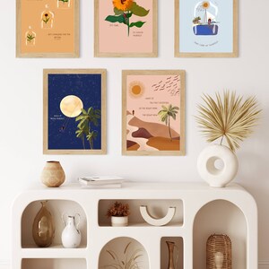 May include: A set of six minimalist wall art prints with inspirational quotes and nature-inspired imagery. The prints feature a variety of colours, including blue, green, yellow, and brown. The prints are framed in natural wood frames.