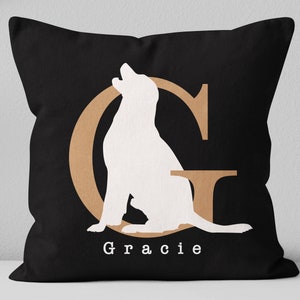 K&ouml;nnte beinhalten: Schwarzes Kissen mit einer wei&szlig;en Silhouette eines Hundes, der in einem braunen Umriss des Buchstabens G sitzt. Der Text "Gracie" ist unter dem Hund gedruckt.
